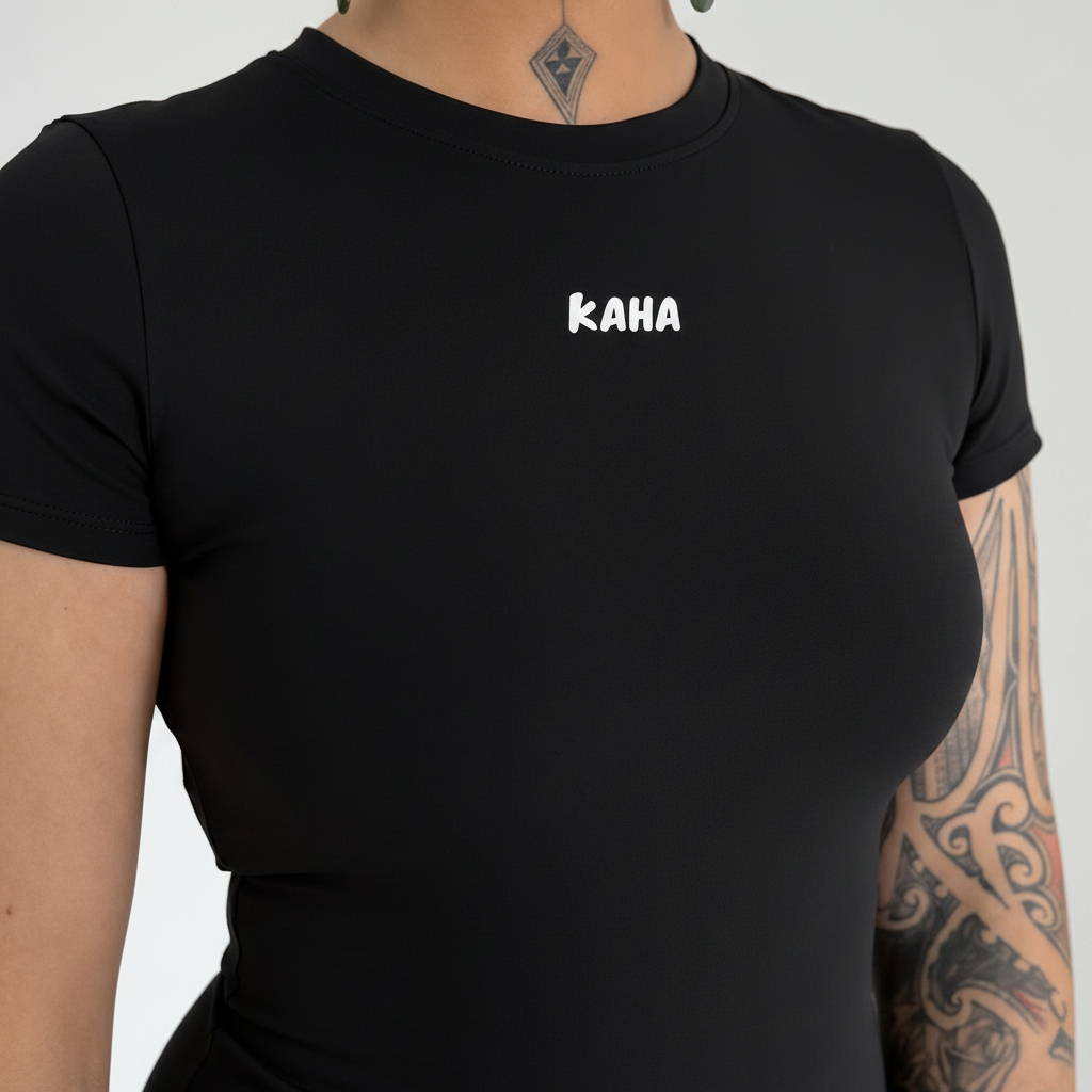 KAHA fitted black short sleeve performance t-shirt with crew neckline and white chest logo on a tattooed model