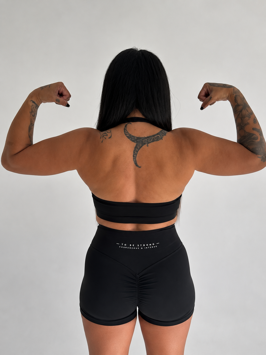 KAHA black high-waisted scrunch shorts with V-shaped back contour and signature text on the waistband