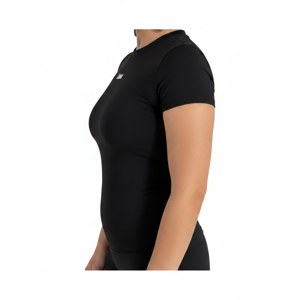 Side profile of a woman wearing a KAHA black fitted short sleeve performance t-shirt with a crew neckline